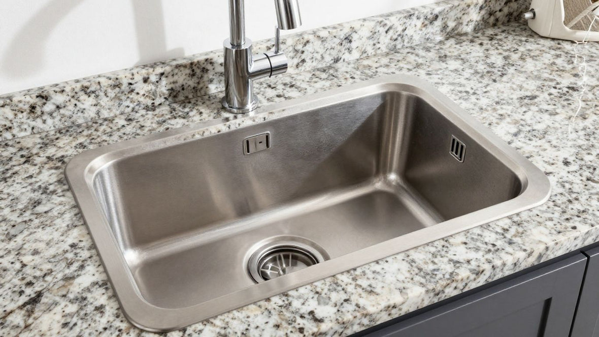 Kitchen sink complementing granite countertop