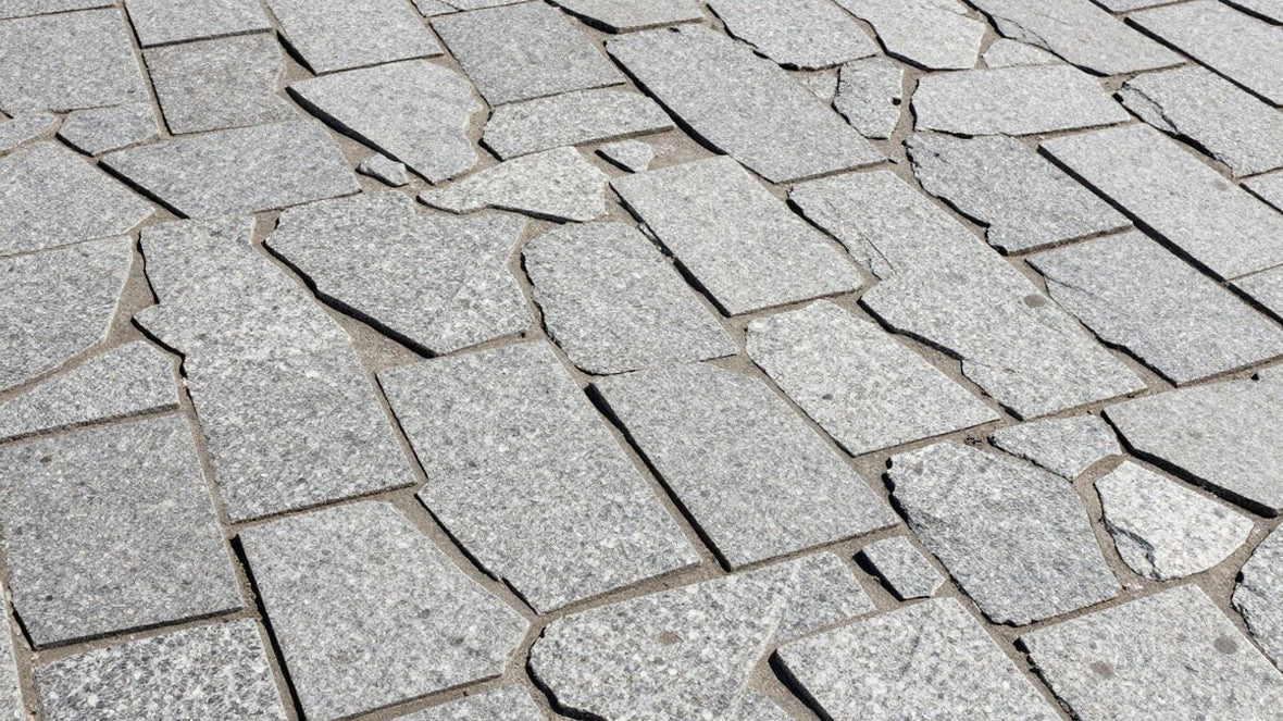 Granite sett paving stones forming a textured pathway.
