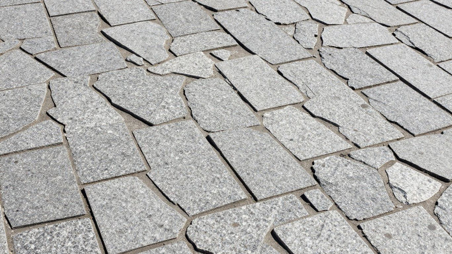 Granite sett paving stones forming a textured pathway.