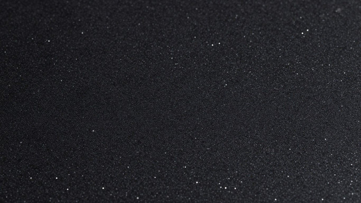 Black sparkle kitchen worktop with reflective particles.