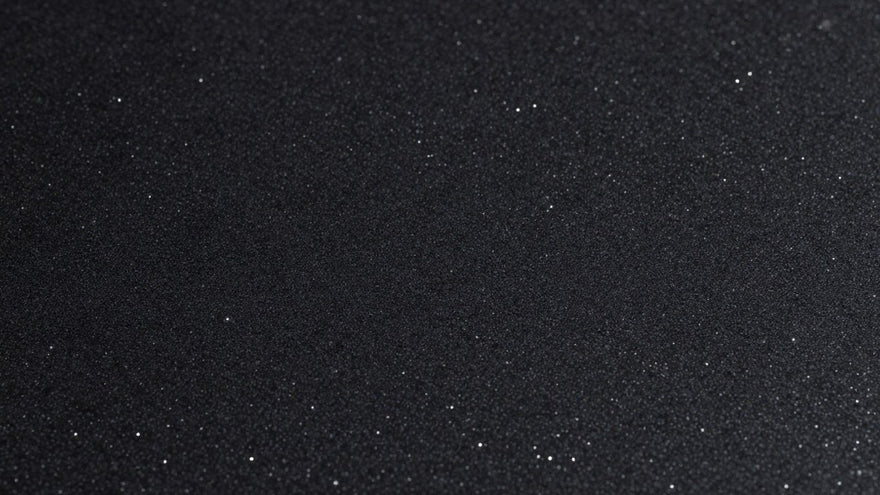 Black sparkle kitchen worktop with reflective particles.