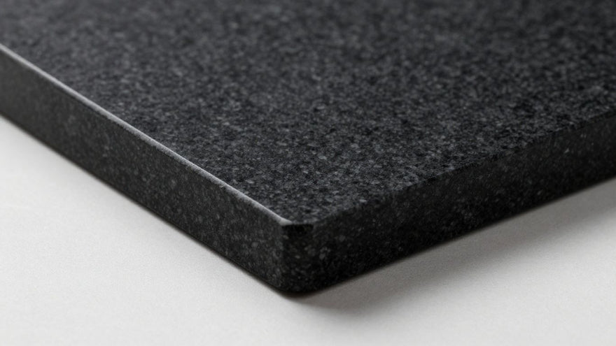 Black granite chopping board on a clean surface.