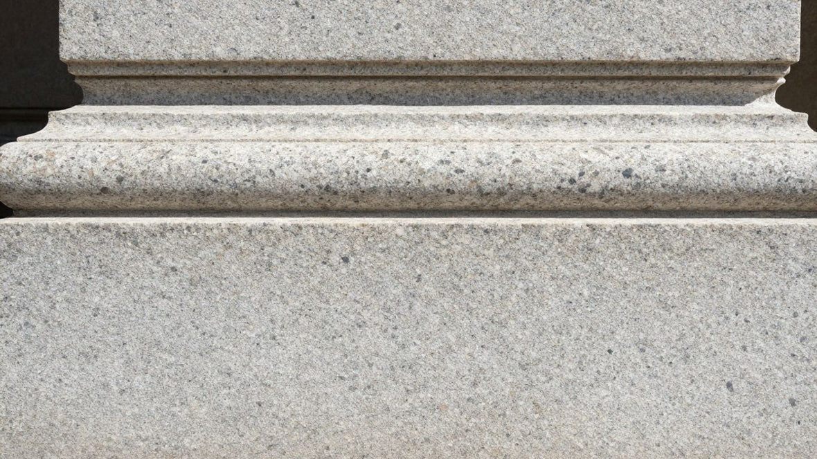 Polished granite building facade, showing texture and strength.