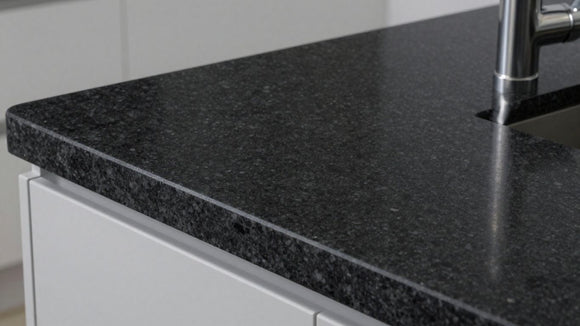 Granite black kitchen worktop with subtle reflections.